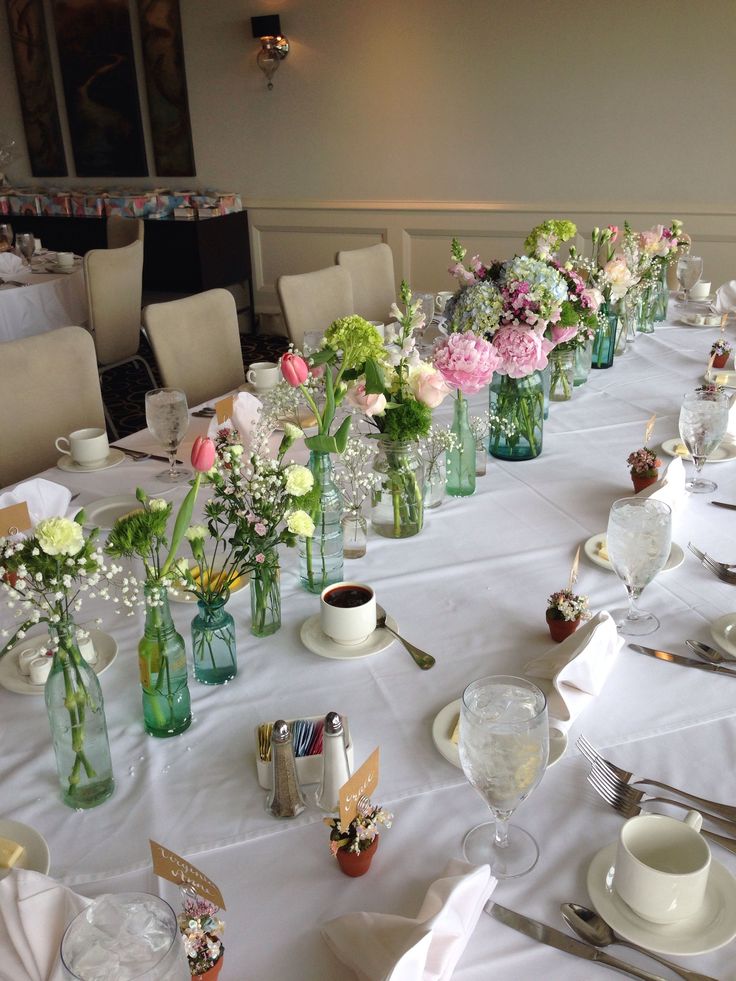 a long table is set with flowers in vases