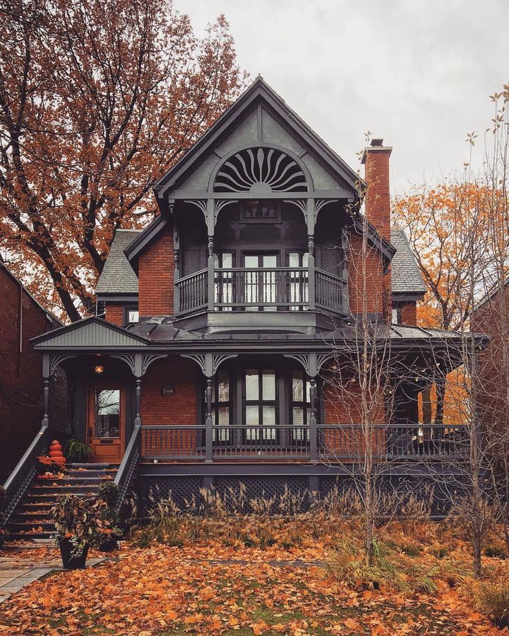 an old victorian style house in the fall