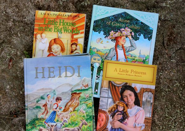 four children's books are laying on the ground