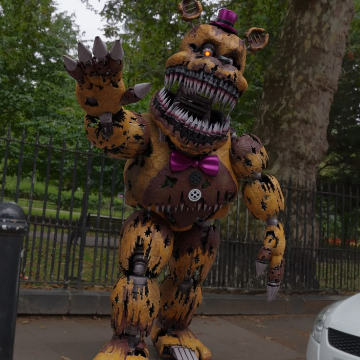 an inflatable costumed animal is standing next to a trash can