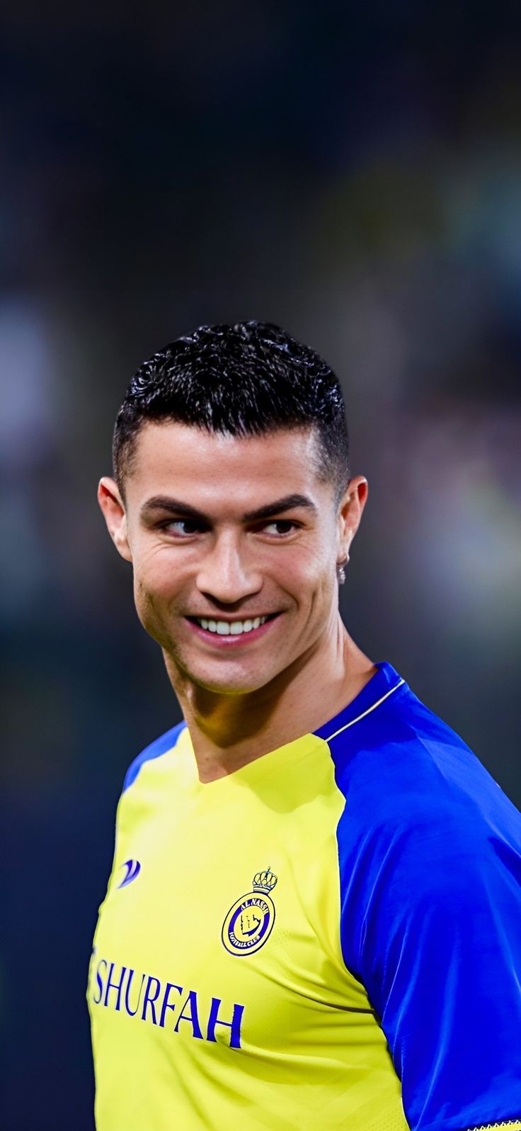 a soccer player is smiling and wearing a blue and yellow uniform with the word shufrah on it