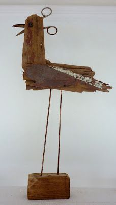 a bird sculpture made out of wood and wire