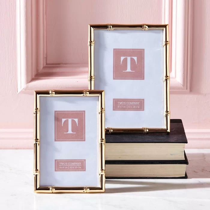 three framed books sitting on top of each other