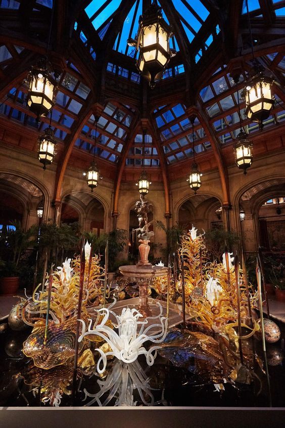 the inside of a building with many lights and decorations