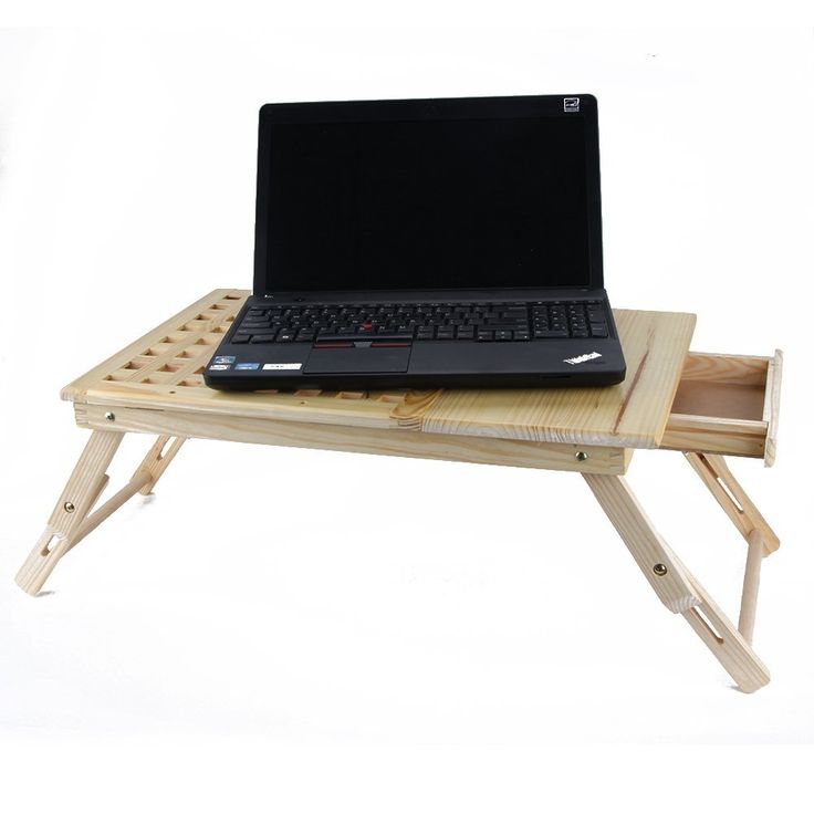 a laptop computer sitting on top of a wooden table with a tray underneath it that holds a keyboard and mouse