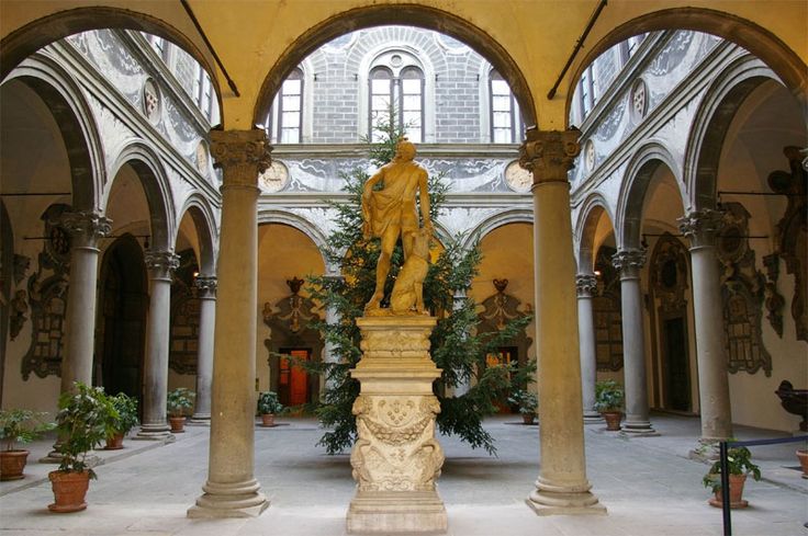 a statue is in the middle of an indoor courtyard