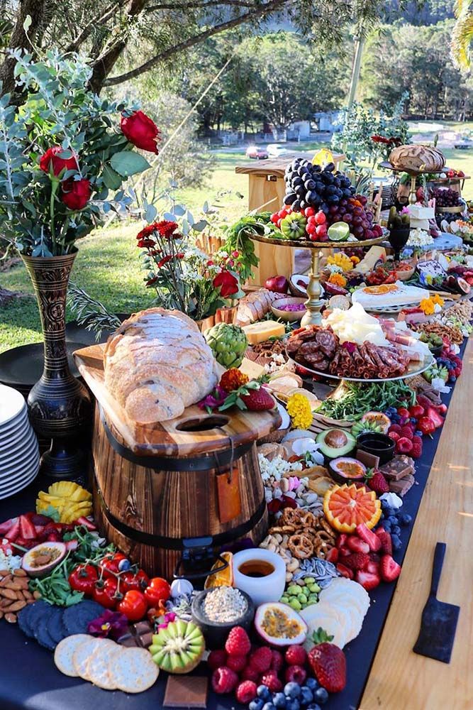 a long table covered with lots of food and flowers on it's side,