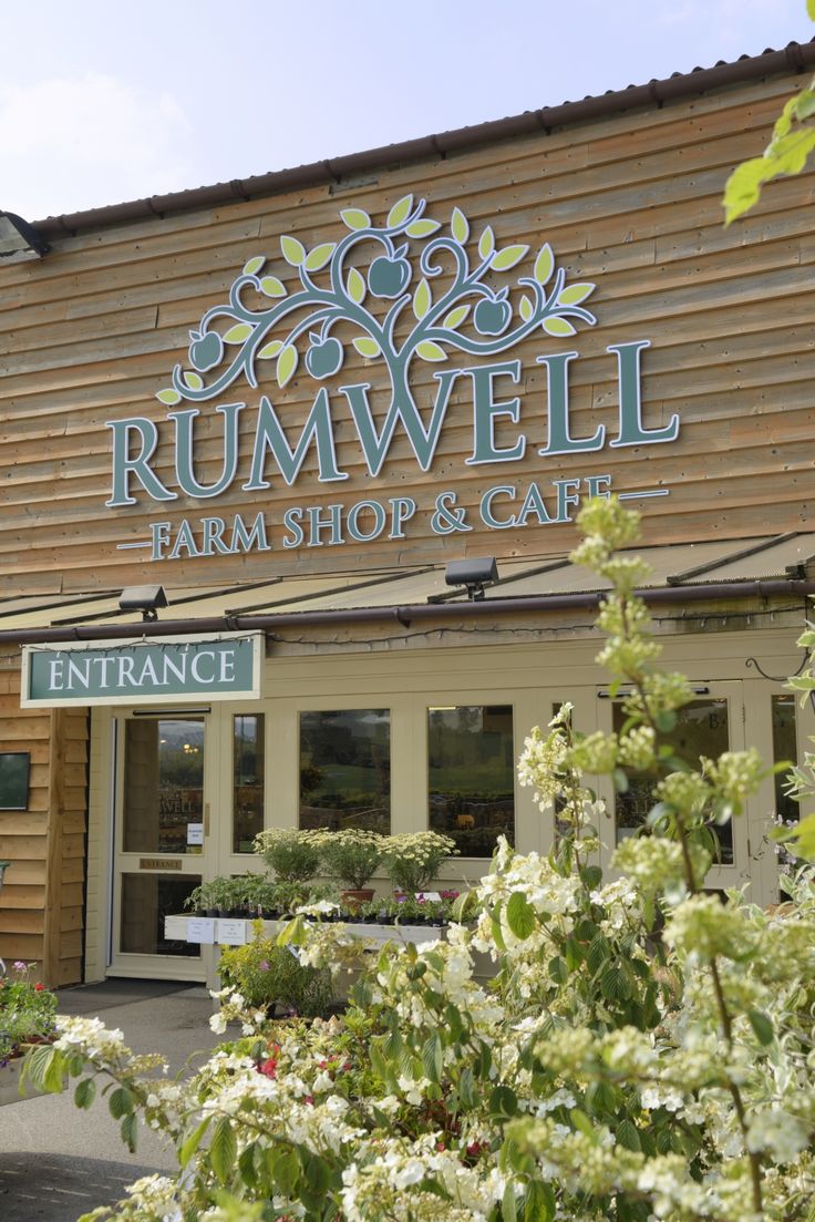 the entrance to rummwell farm shop and gart with white flowers in front