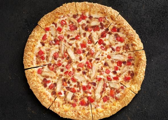 a pizza that has been cut into eight pieces and is sitting on a black surface