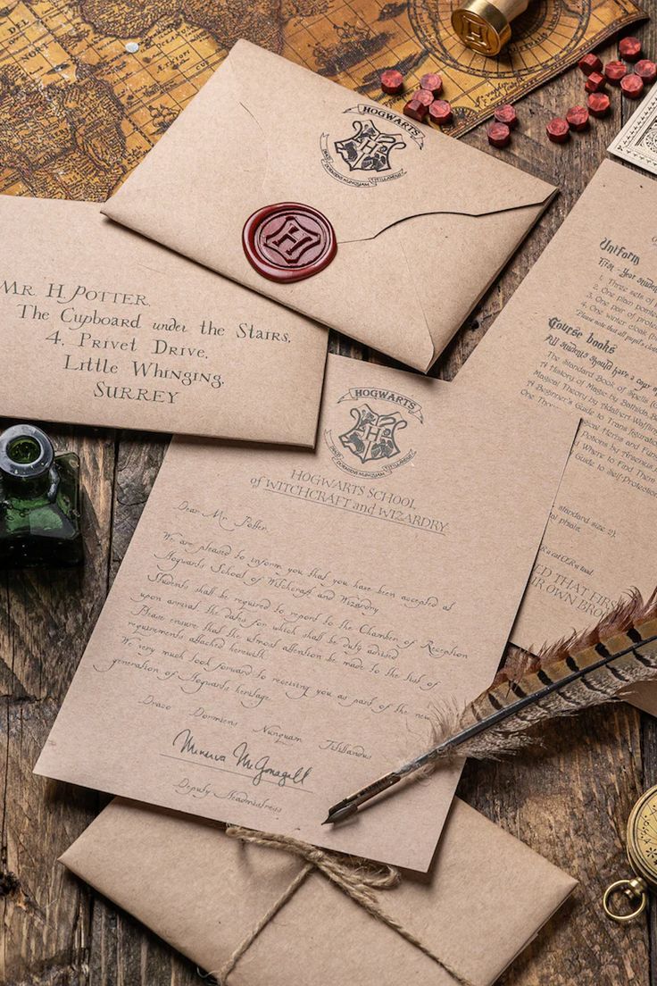 an old fashioned letter and envelopes on a wooden table next to some other items