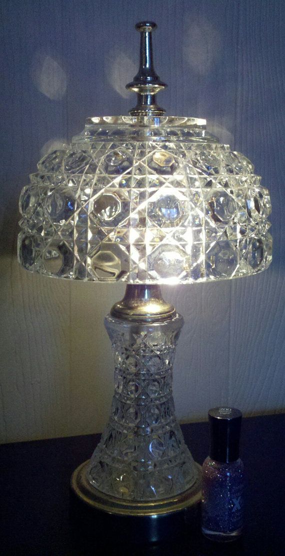 a glass lamp sitting on top of a table