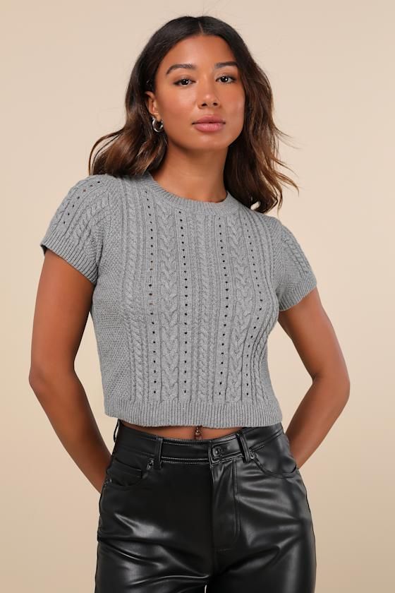 Your autumn style will be truly special with a trendy must-have like the Lulus Modish Ways Heather Grey Cable Knit Short Sleeve Sweater Top! This soft and stretchy sweater (with a subtle heathered effect throughout) boasts a variety of classic designs, including cable, seed, and ribbed knit textures (plus pierced detailing), that makes this piece truly unique. A timeless crew neckline and a fitted, cropped bodice are framed by cute short sleeves, while contrasting ribbed knit trim at the necklin Cozy Fitted Crew Neck Knit Top, Fitted Cable Knit Cropped Sweater For Layering, Heather Knit Sweater For Fall, Gray Knit Cropped Sweater Casual Style, Trendy Gray Knit Top With Crew Neck, Gray Crew Neck Cropped Sweater For Spring, Chic Soft Knit Gray Tops, Casual Gray Knit Cropped Sweater, Trendy Gray Crew Neck Knit Top