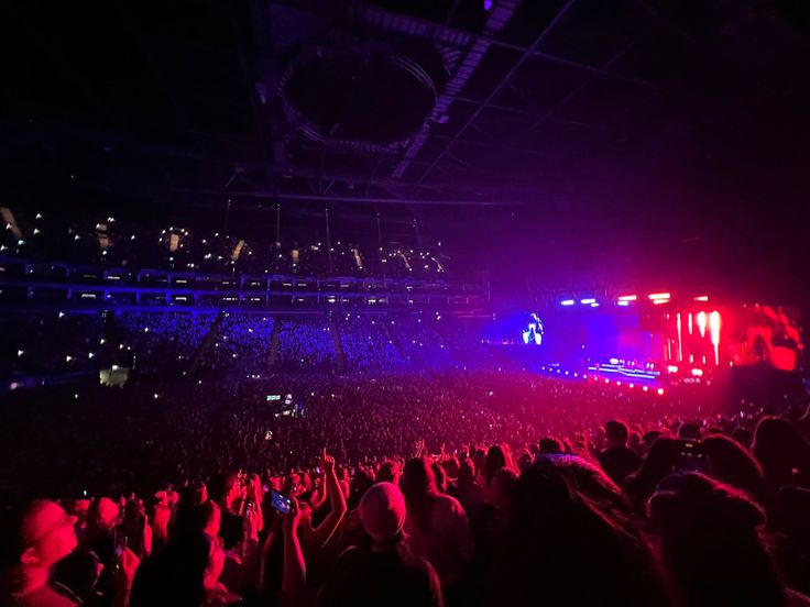 a large crowd at a concert in the dark