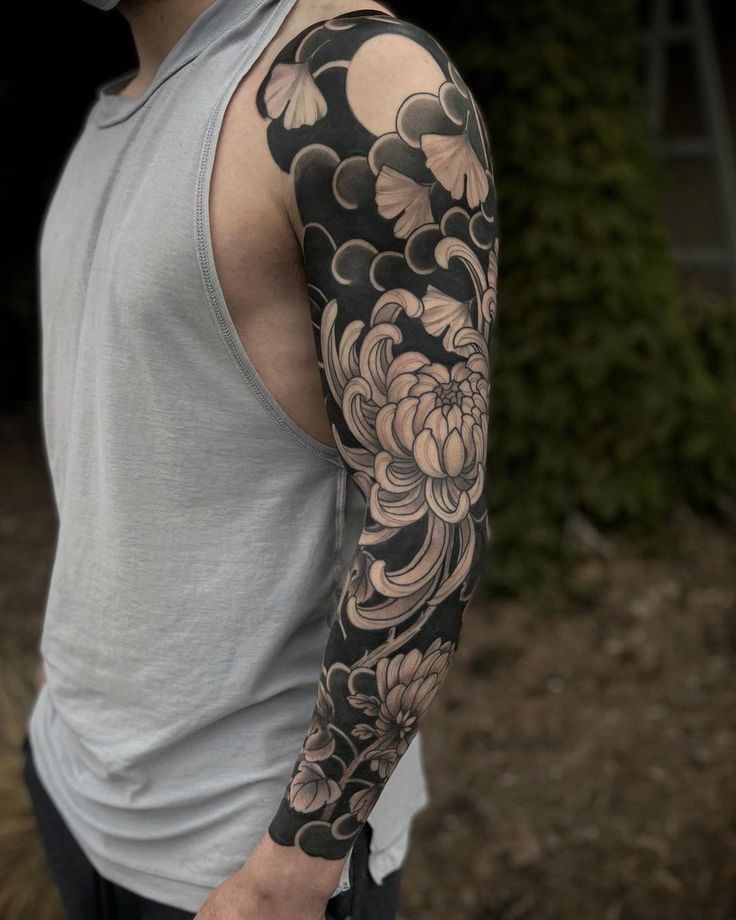 a man with a flower tattoo on his arm