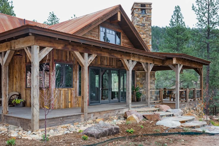 a wooden house sitting in the middle of a forest