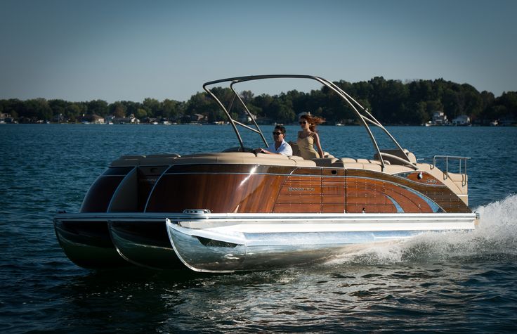 two people are riding on the back of a boat