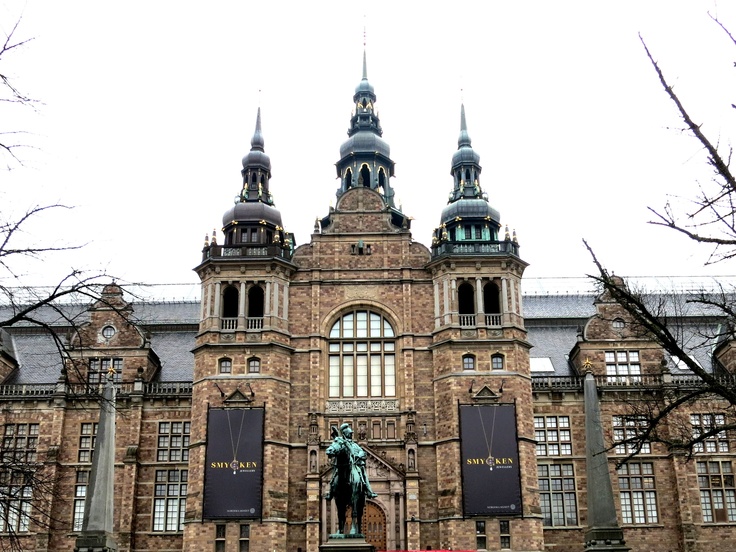 an old building with a statue in front of it