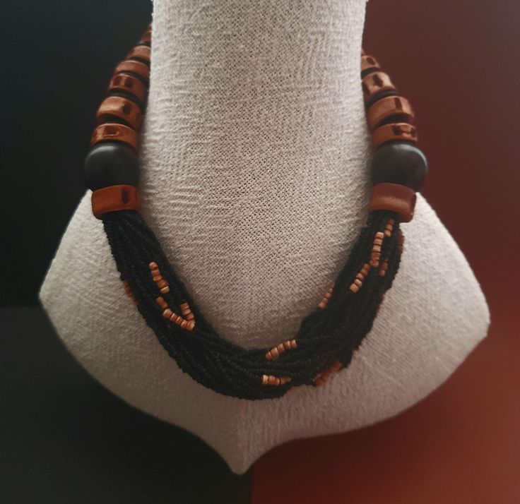 An opulent Necklace with fish vertebrate and ebony beads.Pierced fish vertrebrate are allready known as jewelry from the neolithic era. Rocailles beads made of glass and clay are inserted in the center. Size of ebony bead: 23 mm Length: 52 cm or 20,47 inch Unique Black Jewelry With Large Beads, Adjustable Black Jewelry With Wooden Beads, Traditional Black Multi-strand Jewelry, Handmade Ebony Necklaces For Gifts, Unique Wooden Beads For Jewelry Making, Artisan Multi-strand Wooden Beads, Oval Wooden Beads Jewelry Gift, Unique Brown Jewelry With Polished Beads, Handmade Ebony Necklace For Gift