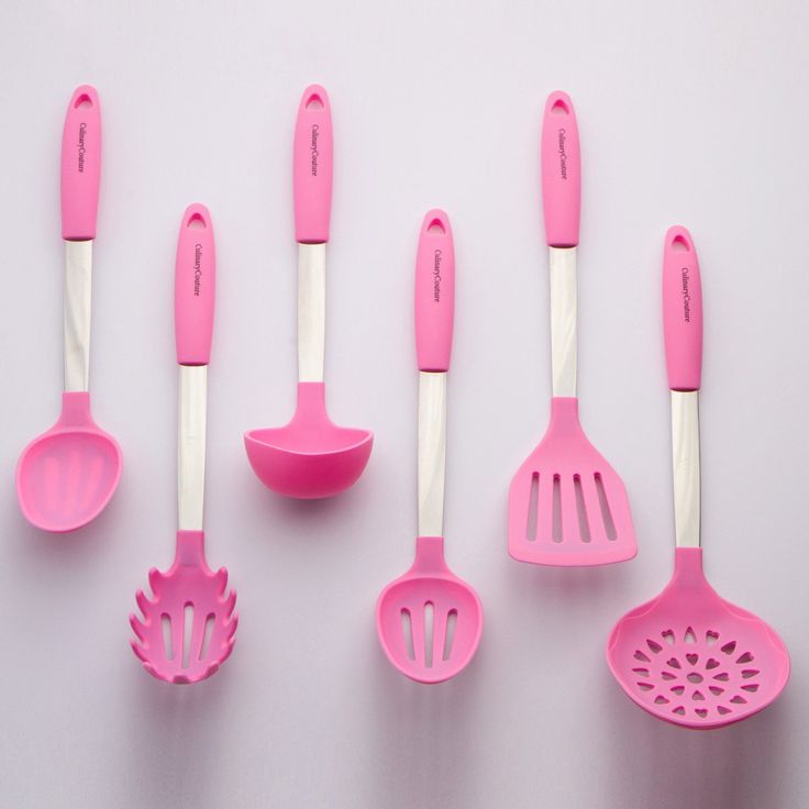 pink kitchen utensils lined up in a row