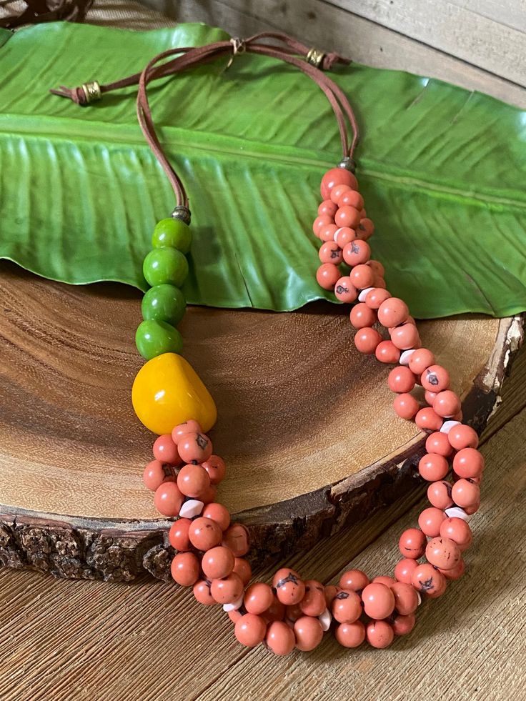 Unique Orange Necklaces For The Beach, Unique Orange Necklace For Beach, Unique Orange Beach Necklaces, Unique Multicolor Necklaces For The Beach, Unique Green Fair Trade Jewelry, Nature-inspired Multicolor Beaded Necklaces As Gift, Orange Fair Trade Jewelry Gift, Fair Trade Orange Jewelry Gift, Multicolor Beaded Necklaces With Nature-inspired Style