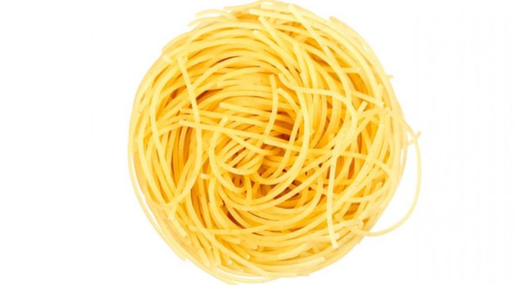 a ball of yellow pasta on a white background