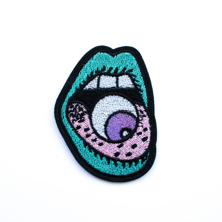 a close up of a patch on a white surface with a blue mouth and tongue