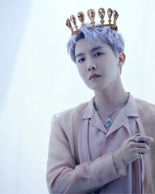 a man with blue hair wearing a crown