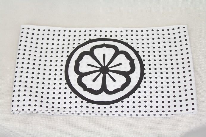 a black and white polka doted cloth with a flower on it's center