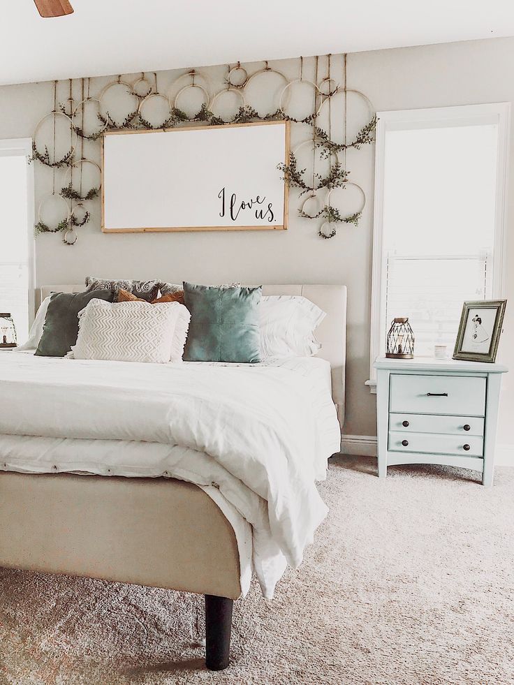 a bedroom with a bed, dressers and pictures on the wall above it's headboard