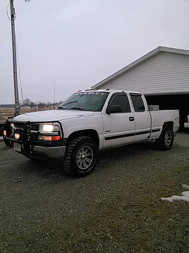 a white truck parked in front of a house