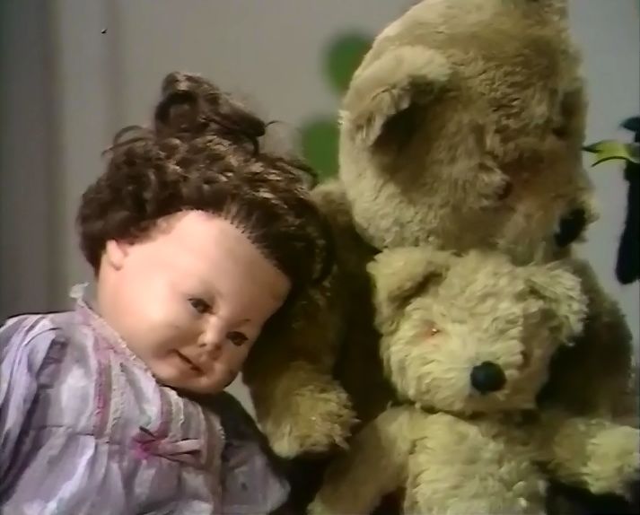 a small child standing next to two teddy bears