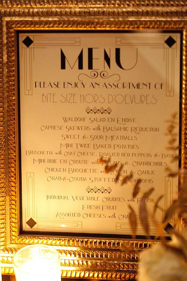 a menu is displayed in front of a lit candle