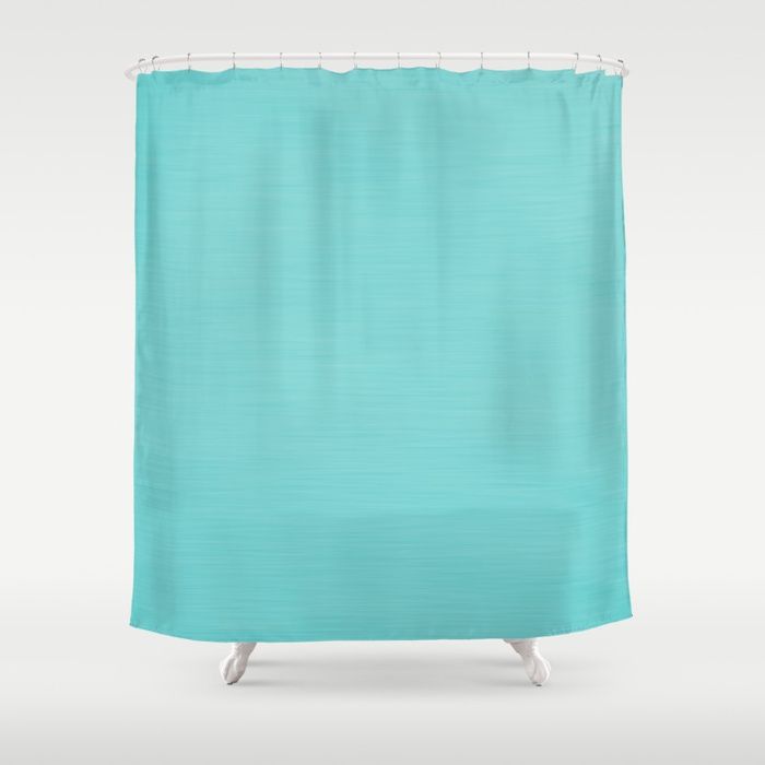 a blue shower curtain with white trim