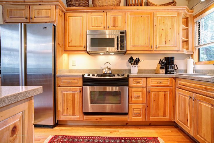 a kitchen with wooden cabinets and stainless steel appliances