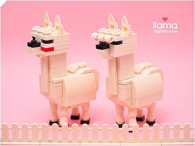 two white llamas standing next to each other in front of a pink background