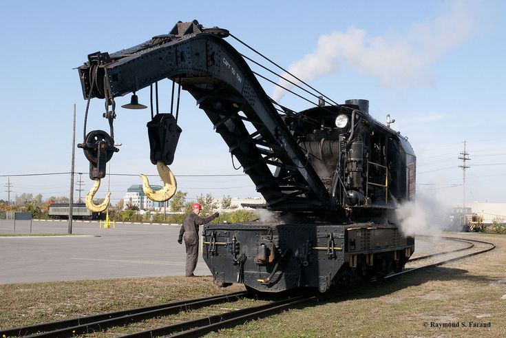 an old train being lifted by a crane