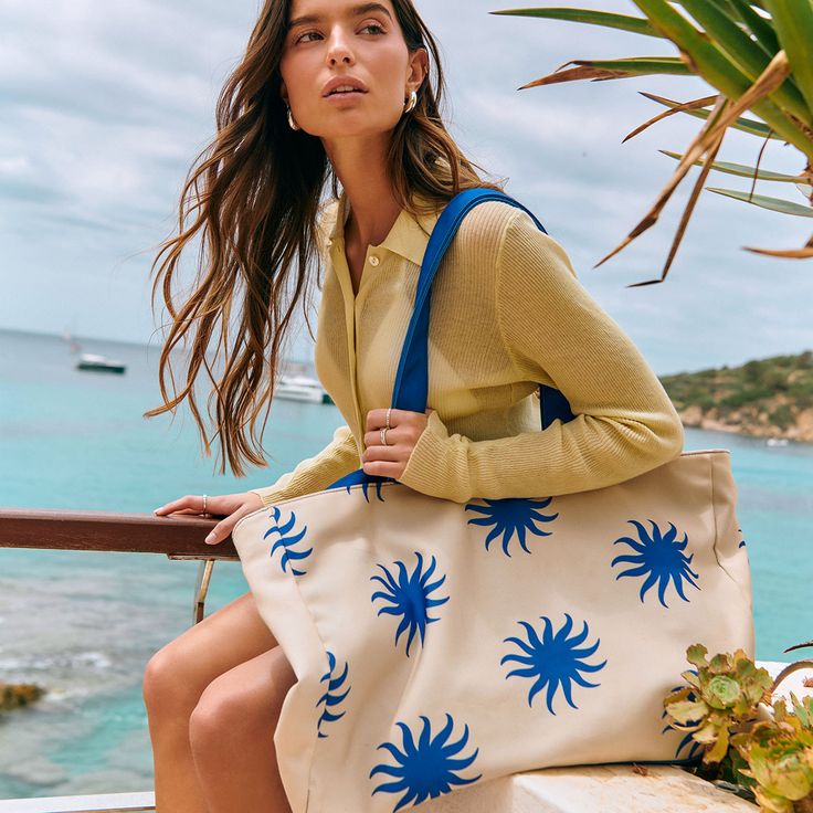 Be the ultimate goddess with BURGA's Beach Bag. Imagine strutting down the beach, bag in hand, catching everyone's eye with its vibrant patterns and luxe look. It's roomy enough to fit all your essentials (and then some), but sleek enough to make a fashion statement. Whether you're hitting up a tropical paradise or just lounging by the pool, this bag screams style, sass, and totally you.    Features:     Dimensions: 50 x 11 x 35 cm (19.7 x 4.4 x 13.8 inches)     Made from durable canvas: 35% cotton and 65% polyester.     Secured with magnetic fasteners.     Interior pocket for phone, keys, and small items.     Spacious design for all your essentials.     Part of our exclusive Resort Collection.     Care Instructions:     Spot clean with mild soap and water.     Hand wash with cold water an Sand-colored Travel Bags For Beach Season, Sand-colored Shoulder Bag For Summer Travel, Summer Sand-colored Tote Beach Bag, Beach Season Sand-colored Tote Shoulder Bag, Beach Season Sand Tote Shoulder Bag, Sand-colored Tote Shoulder Bag For Beach Season, Sand Tote Shoulder Bag For Beach Season, Chic Summer Beach Canvas Bag, Trendy Beach Bag With Double Handle For Day Out