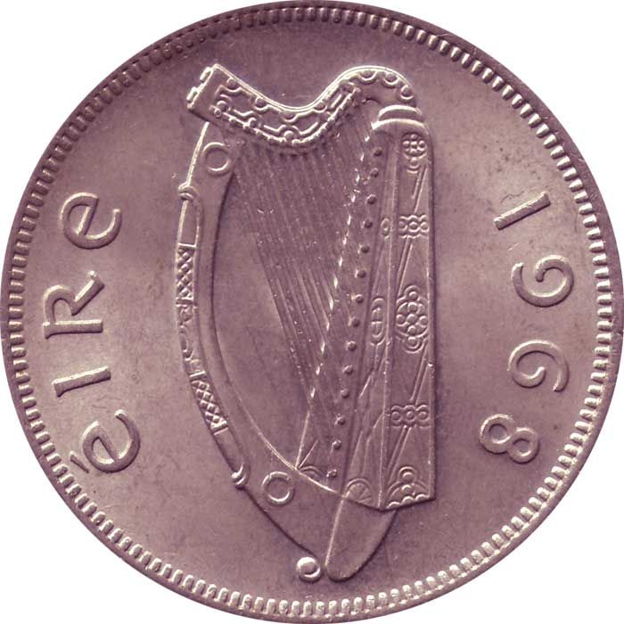 an old coin with a harp on the front and side, isolated against a white background