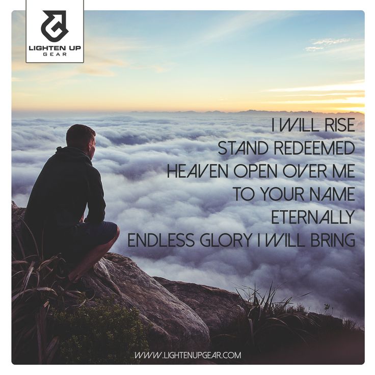 a man sitting on top of a mountain looking at the sky with clouds below him