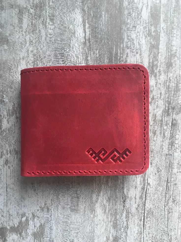 100 % full-grain handmade leather wallet. Slim and small red bifold wallet. Precisely made from high quality cow leather. Lasts for years, therefore is a perfect gift. The wallet is engraved with an ancient stylized grass-snake sign. Wallet is made from full grain cow leather. Crazy horse is a specially processed leather type that gives it an antique appearance. This type of leather is long lasting, very durable and any scratches or rubs turn it to a different shade, bend line also fades to a di Red Rfid Blocking Wallets For Everyday Use, Red Rfid Blocking Wallets, Red Rfid Blocking Wallet, Red Bifold Wallet For Everyday Use, Red Leather Trifold Wallet For Daily Use, Handmade Red Wallet For Everyday Use, Red Leather Wallet With Card Slots, Red Trifold Wallet For Daily Use, Handmade Red Wallet