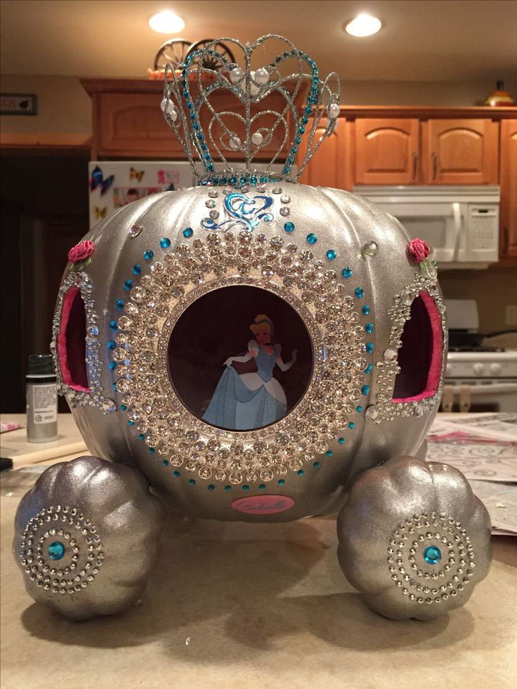 a silver carriage with a princess in the center and blue jewels on it's wheels