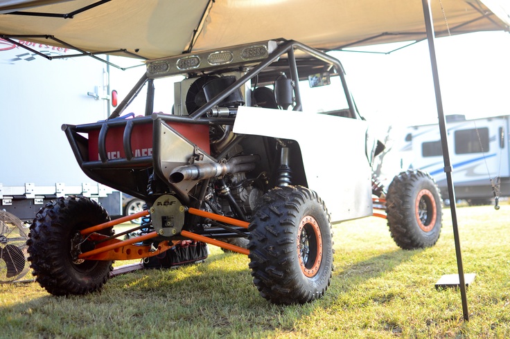 an off road vehicle parked under a tent