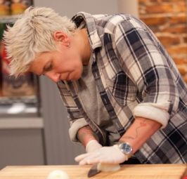 a man in plaid shirt preparing food on top of a wooden cutting board and oven mitts