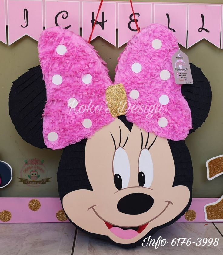 a pink and black minnie mouse head on display