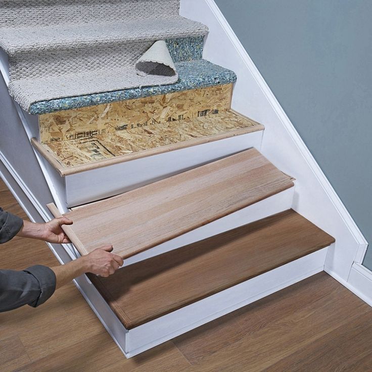 a man that is standing on some stairs with his feet in the floor and handrails