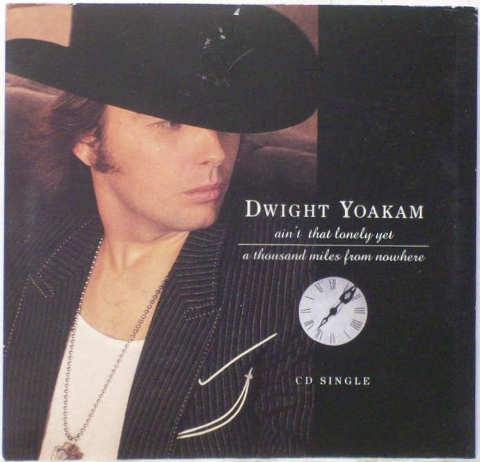 a man wearing a black cowboy hat with a clock on it's forehead and the words dwigght yoakam