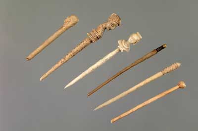 an assortment of ancient artifacts including toothbrushes and canes are shown in this image