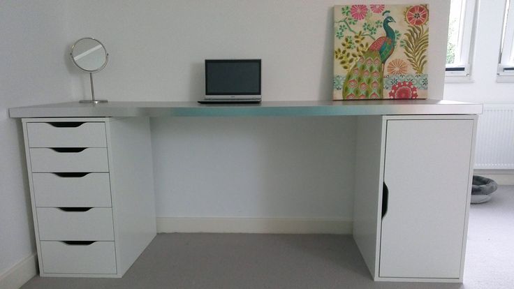 a white desk with drawers and a laptop on it