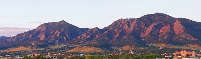 the mountains are covered in trees and buildings