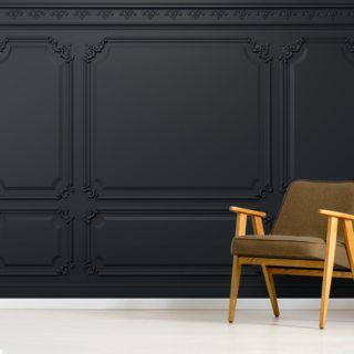 a chair sitting in front of a wall with black paneled panels on it's sides